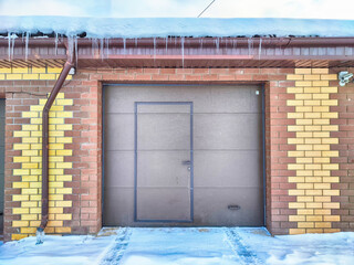 The metal gate of the new brick garage. Location, background, texture
