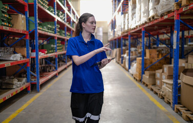 Fototapeta premium Distribution warehouse worker using digital tablet checking inventory storage on shelf. Female inventory supervisor or logistic engineer working at storage room in storehouse. Goods supply management
