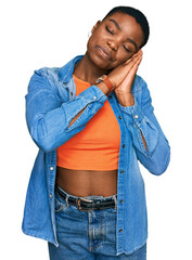 Young african american woman wearing casual clothes sleeping tired dreaming and posing with hands together while smiling with closed eyes.