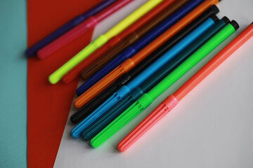 Fototapeta premium Colorful Crayons and flomasters on paper background stock photo