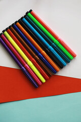 Colorful Crayons and flomasters on paper background stock photo