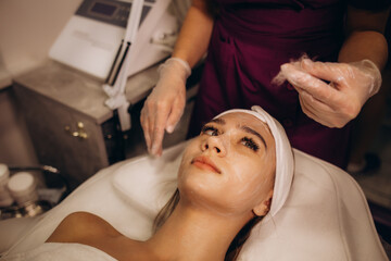 a cosmetologist performs a silky face procedure on a woman