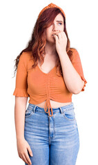 Young beautiful woman wearing casual clothes looking stressed and nervous with hands on mouth biting nails. anxiety problem.