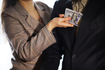 Businessmen secretly passing money - bribery and corruption concepts