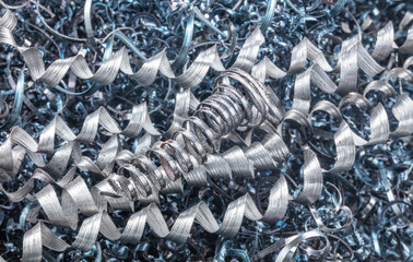 Metal spiral shavings after working on a lathe. Angled view. Background for design.