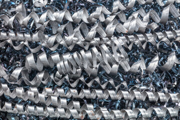 Metal spiral shavings after working on a lathe. Angled view. Background for design.