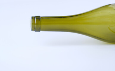 The neck of an empty bottle is on a white background. Green glass. Recycle. Copy space.