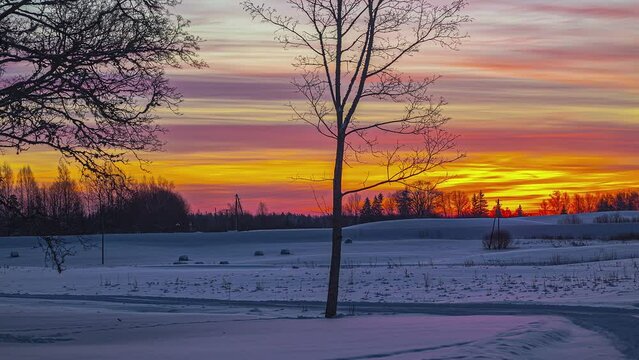 Stunning winter time lapse of snow fields glowing with vivid orange sunset