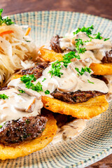 potato pancakes with meat, mushrooms and creamy sauce