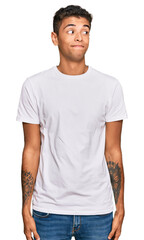 Young handsome african american man wearing casual white tshirt smiling looking to the side and staring away thinking.