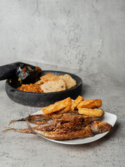 sambal terasi on a mortar with tofu on a marble background