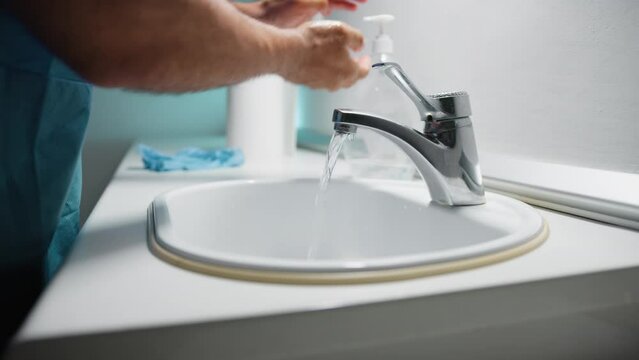 Doctor washes his hands before surgery