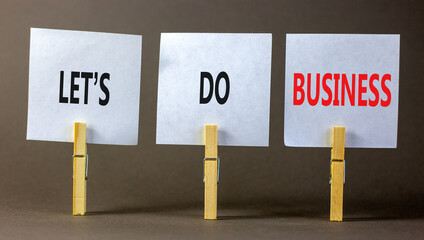 let is do business symbol. Concept words let is do business on beautiful white paper on clothespin. Beautiful grey table grey background. let is do business concept. Copy space.