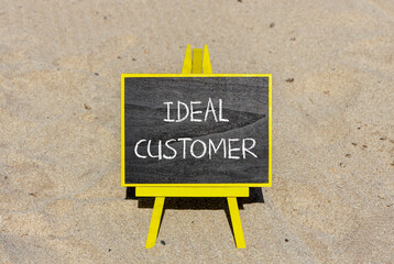 Ideal customer symbol. Concept words Ideal customer on beautiful black chalk blackboard. Chalkboard. Beautiful sand background. Business ideal customer concept. Copy space.