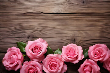 Pink roses on wood background