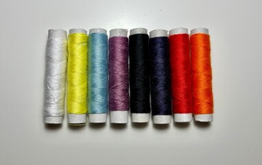 spools of thread on a white background. multi-colored threads.