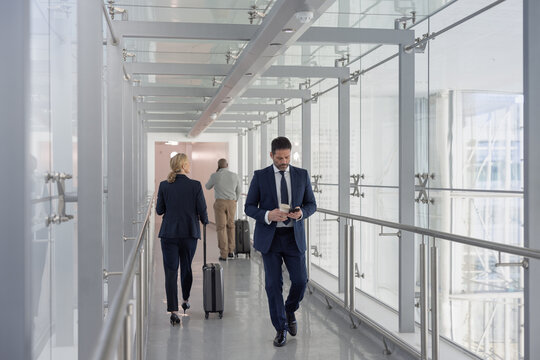 Business executives walking through airport terminal