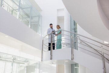 Doctors in a modern hospital looking at results on a digital tablet