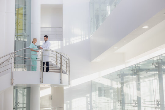 Doctors in a modern hospital looking at results on a digital tablet