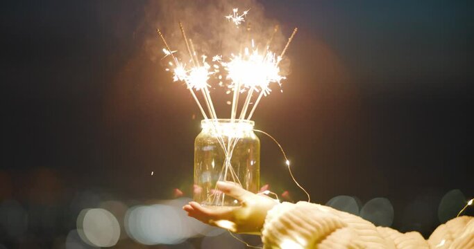 Close-up photo of hand holding  sparklers