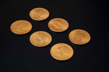 US gold coins. vintage coins on a black background.