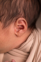 Fototapeta premium Little newborn baby earlobe earring ear preauricular appendix listen