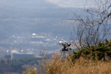 Telescope on a tripod in the mountains for observation