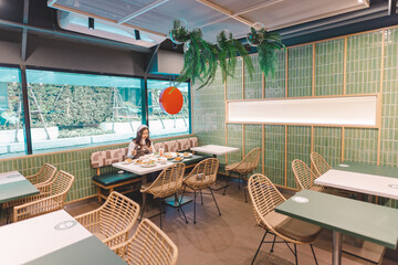 A woman eating food in a Japanese restaurant