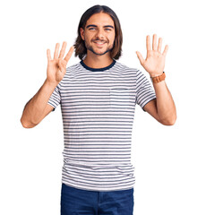 Young handsome man wearing casual clothes showing and pointing up with fingers number nine while...