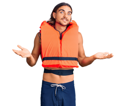 Young handsome man wearing nautical lifejacket clueless and confused expression with arms and hands raised. doubt concept.