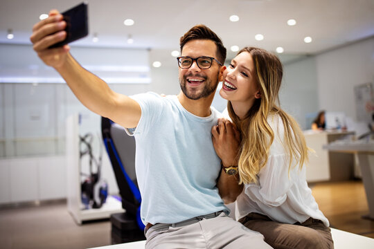 Couple is making selfie using a smart phone. Digital device, artificial intelligence concept. © NDABCREATIVITY