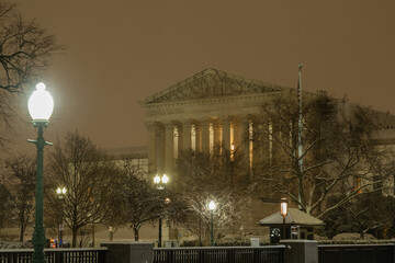 Supreme Court of the United States in winter. Night photo of Supreme Court of the United States in Washington DC in snow. SCOTUS building in snow. Winter Capitol hill, Washington DC.