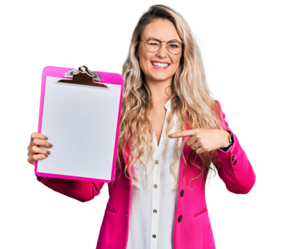 Young blonde woman holding clipboard winking looking at the camera with sexy expression, cheerful and happy face.