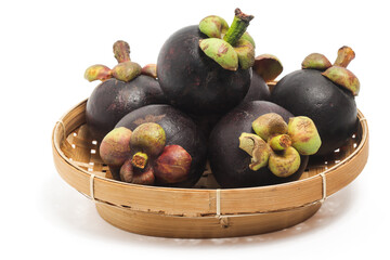 Fresh organic mangosteen delicious fruit in a bamboo basket plate isolated on white background clipping path