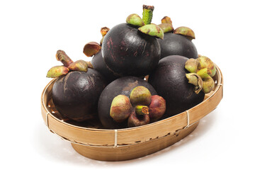 Fresh organic mangosteen delicious fruit in a bamboo basket plate isolated on white background clipping path