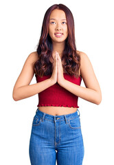 Fototapeta premium Young beautiful chinese girl wearing casual clothes begging and praying with hands together with hope expression on face very emotional and worried. begging.