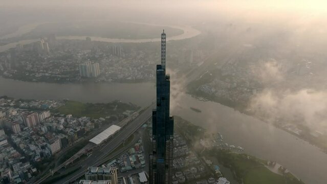 Aerial Shot Of Buildings In City Against Sky During Cloudy Sunrise, Drone Flying Backward Over Cityscape - Saigon Ho Chi Minh City, Vietnam - stock video