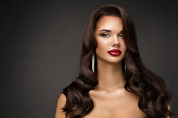 Beautiful Woman Face with Full Red Lips Makeup. Fashion Model Portrait with Wavy Hairstyle over...