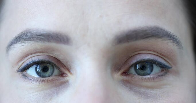 Female eyes with a gray green pupil. Medical eye examination and laser vision correction concept