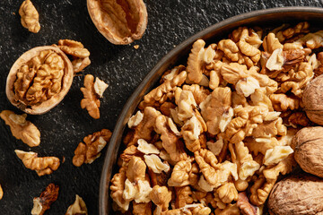A plate with peeled walnut kernels close-up. Top view.