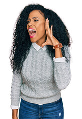 Middle age african american woman wearing casual clothes shouting and screaming loud to side with hand on mouth. communication concept.