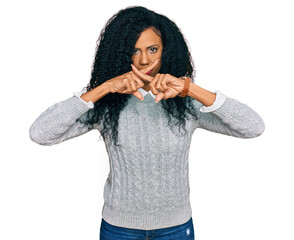 Middle age african american woman wearing casual clothes rejection expression crossing fingers...