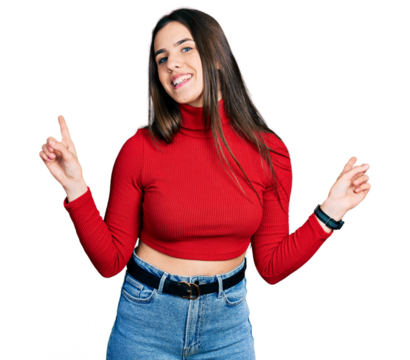 Young brunette teenager wearing red turtleneck sweater smiling confident pointing with fingers to different directions. copy space for advertisement