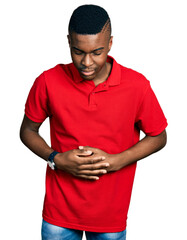 Young african american man wearing casual red t shirt with hand on stomach because indigestion, painful illness feeling unwell. ache concept.