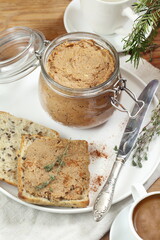 Duck pate with coffee on wooden background