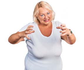 Middle age blonde woman wearing casual white t shirt shouting frustrated with rage, hands trying to strangle, yelling mad
