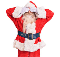 Old senior man with grey hair and long beard wearing traditional santa claus costume covering eyes with hands smiling cheerful and funny. blind concept.