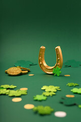 Golden Horseshoe, Gold Coins and Clover Leaves Shamrocks on Green Background for St Patricks Day...