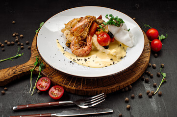 A dish of boiled shrimps with mashed potatoes, greens and vegetables