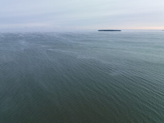 Estonia, Baltic Sea in winter, wind from the shore, view of a small island.